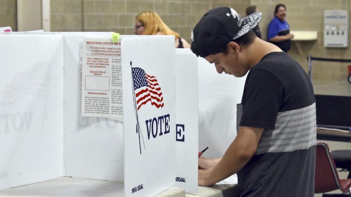 Devin Asbell fills out his primary election ballot Tuesday in Billings, Mont.