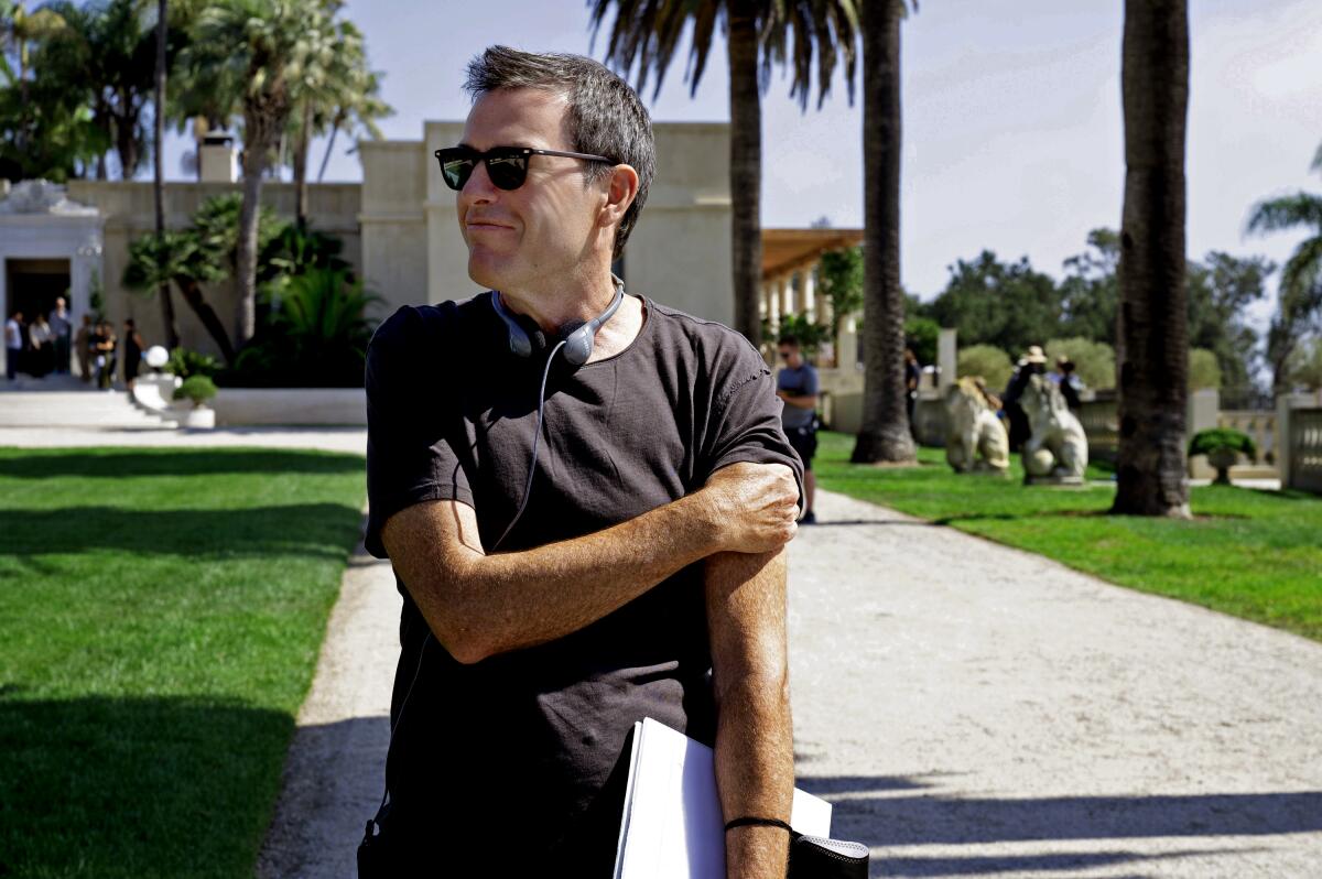 "Succession" director Mark Mylod wears a T-shirt and sunglasses as he walks outside.