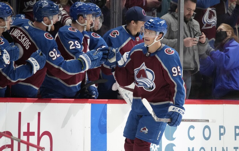 Colorado Avalanche left wing Andre Burakovsky, front, is congratulated as he passes the team box after scoring a goal against the Detroit Red Wings in the second period of an NHL hockey game Friday, Dec. 10, 2021, in Denver. (AP Photo/David Zalubowski)