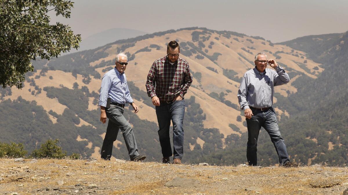 From left, Barry Zoeller, vice president of corporate communications and investor relations for Tejon Ranch Co., Nathan Keith, director of planning, and Greg Medeiros, vice president of community development, tour a part of Tejon Ranch set aside for permanent preservation.