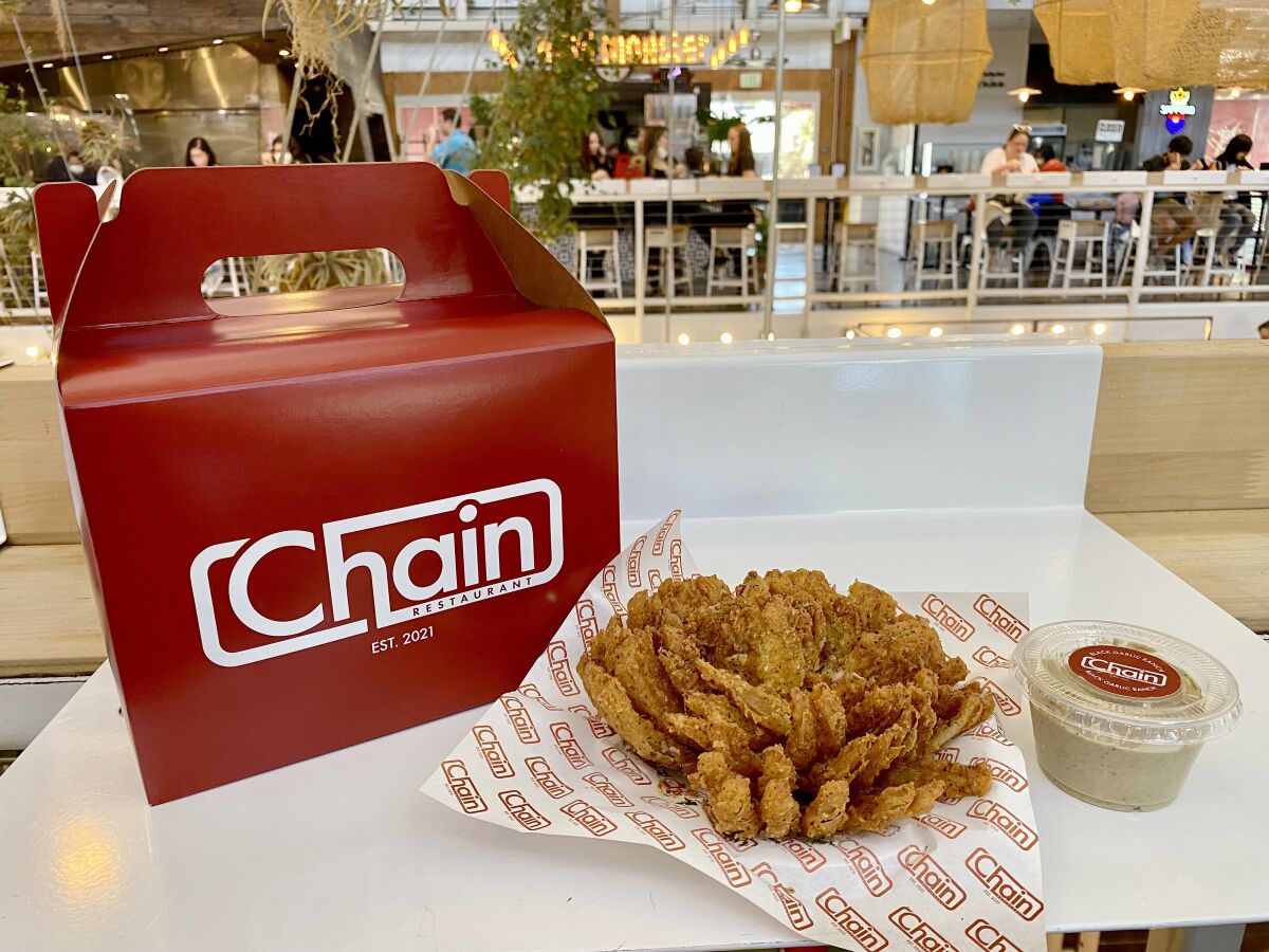 Food and a takeout box from Chain Restaurant, a pop-up concept at the Packing House in Anaheim on Jan. 30.