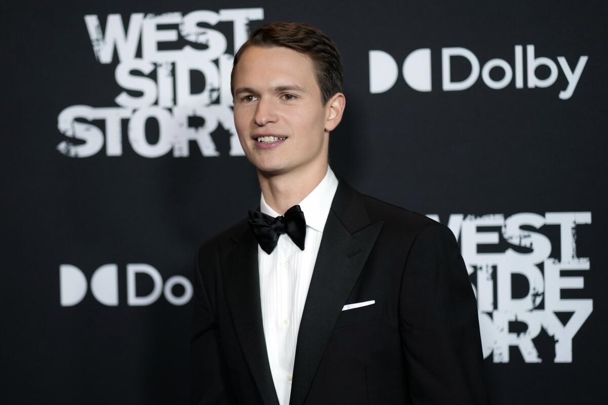 A yound man in a tuxedo at a film premiere