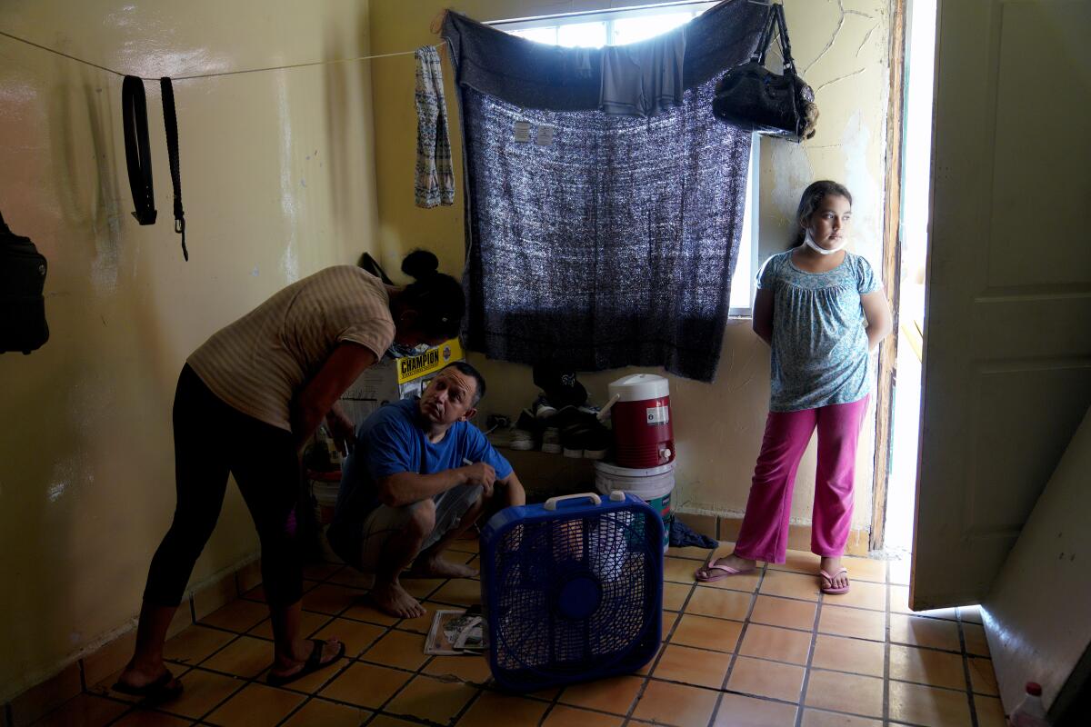 Rudy Brizuela and his wife, Enriqueta Reyes, share a small room at the Cobina Shelter in Mexicali, Mexico, with another family.