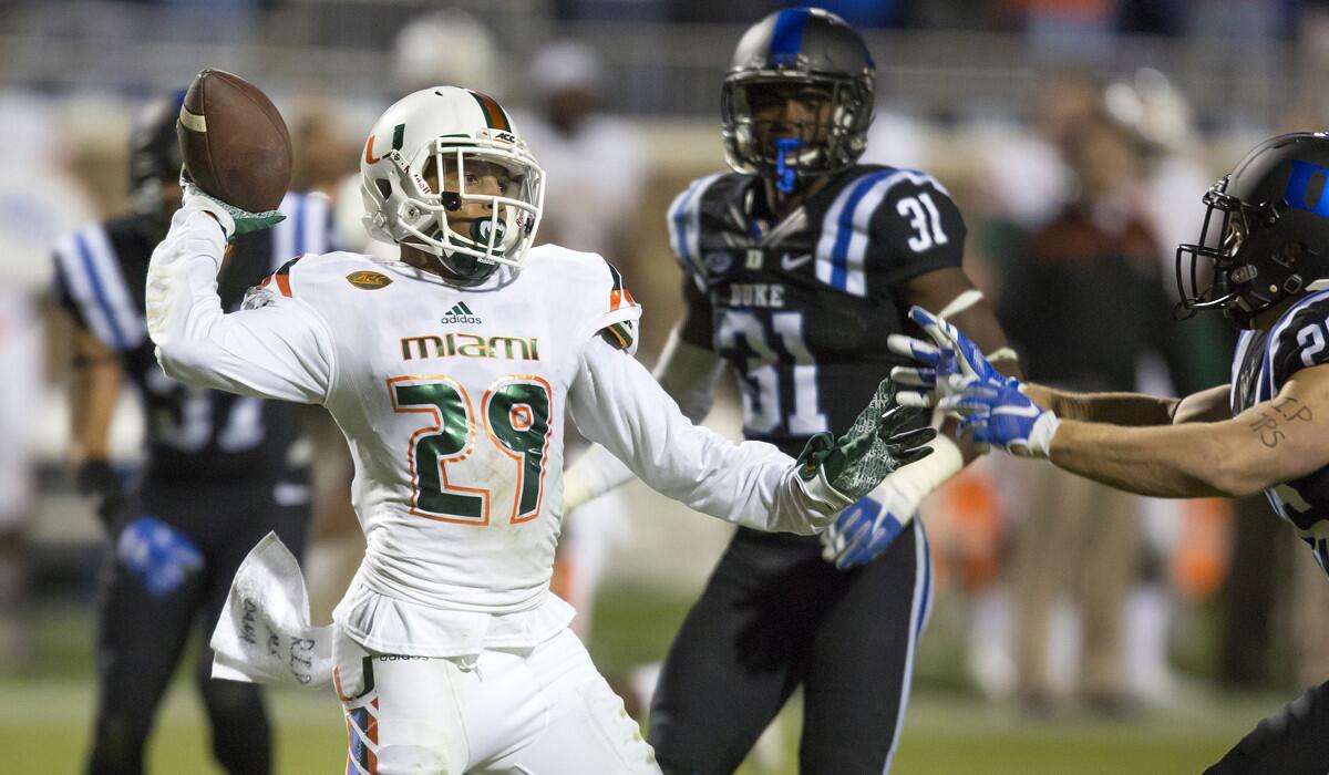 Miami's Corn Elder throws a lateral during a kickoff return which featured multiple laterals before Elder subsequently received the final lateral and scored to beat Duke on Saturday.