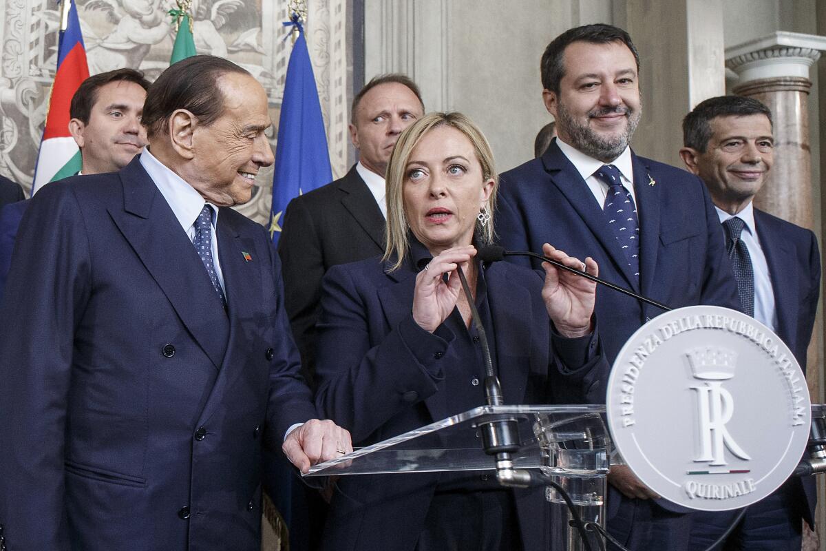 Brothers of Italy leader Giorgia Meloni flanked by former Prime Minister Silvio Berlusconi and politician Matteo Salvini