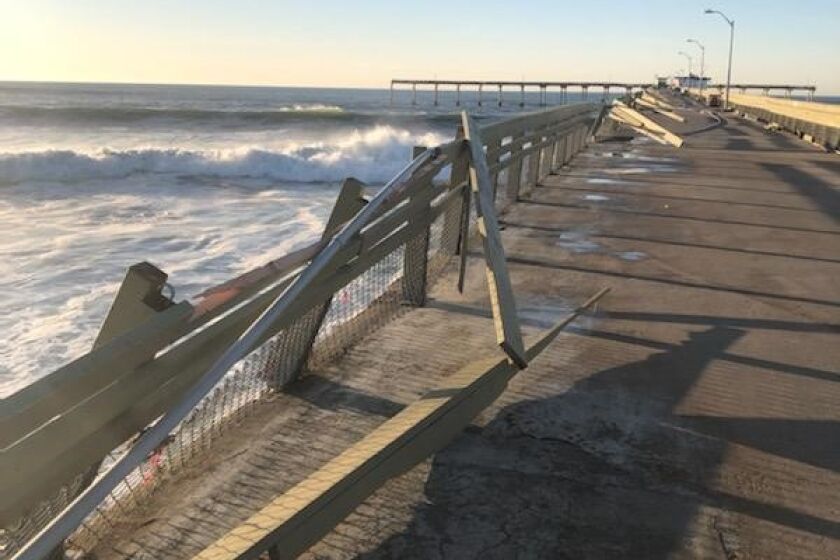 Railing on the south side of the Ocean Beach Pier was damaged by high surf Jan. 11.