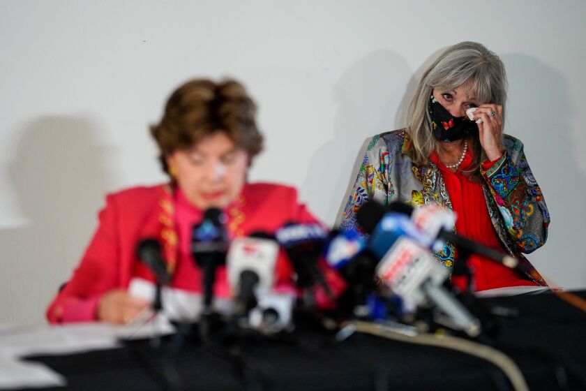 LOS ANGELES, CA - AUGUST 11: Janet Baggett, mother of the late Elizabeth Baggett, wipes her eyes as Attorney Gloria Allred speaks at a press conference on Tuesday, Aug. 11, 2020 in Los Angeles, CA. Allred's film, Allred, Maroko & Goldberg, filed the lawsuit on behalf of the estate of Elizabeth Baggett, whose dead body was allegedly fondled by an on-duty Los Angeles Police Department officer. (Kent Nishimura / Los Angeles Times)