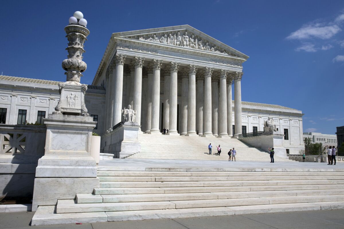 In this April 26, 2014 file photo, people walk on the steps of the U.S. Supreme Court in Washington.