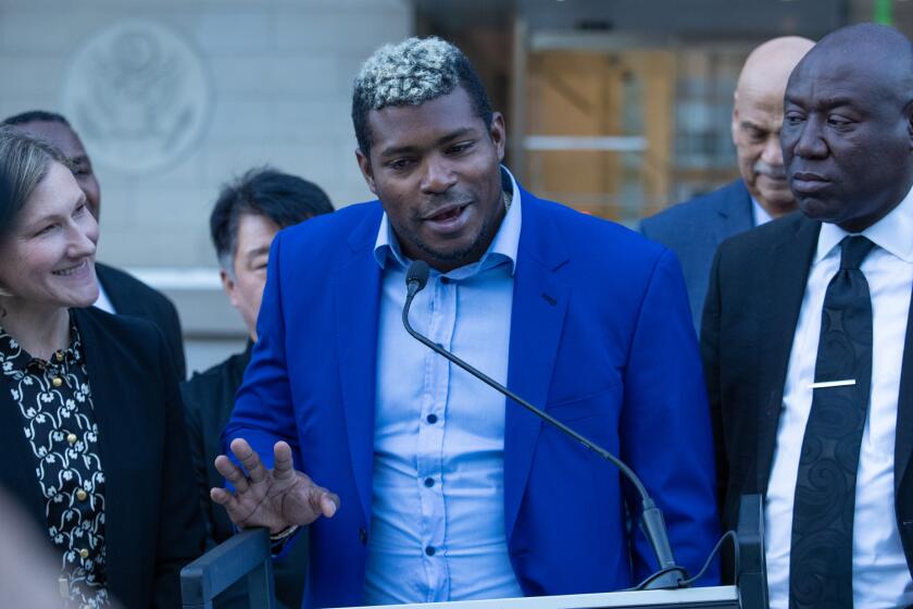 LOS ANGELES, CA - February 11, 2023: Former Dodgers outfielder Yasiel Puig, center, speaks at a news conference outside the federal courthouse in downtown Los Angeles on Saturday February 11, 2023 in Los Angeles, CA. (Brian van der Brug / Los Angeles Times)