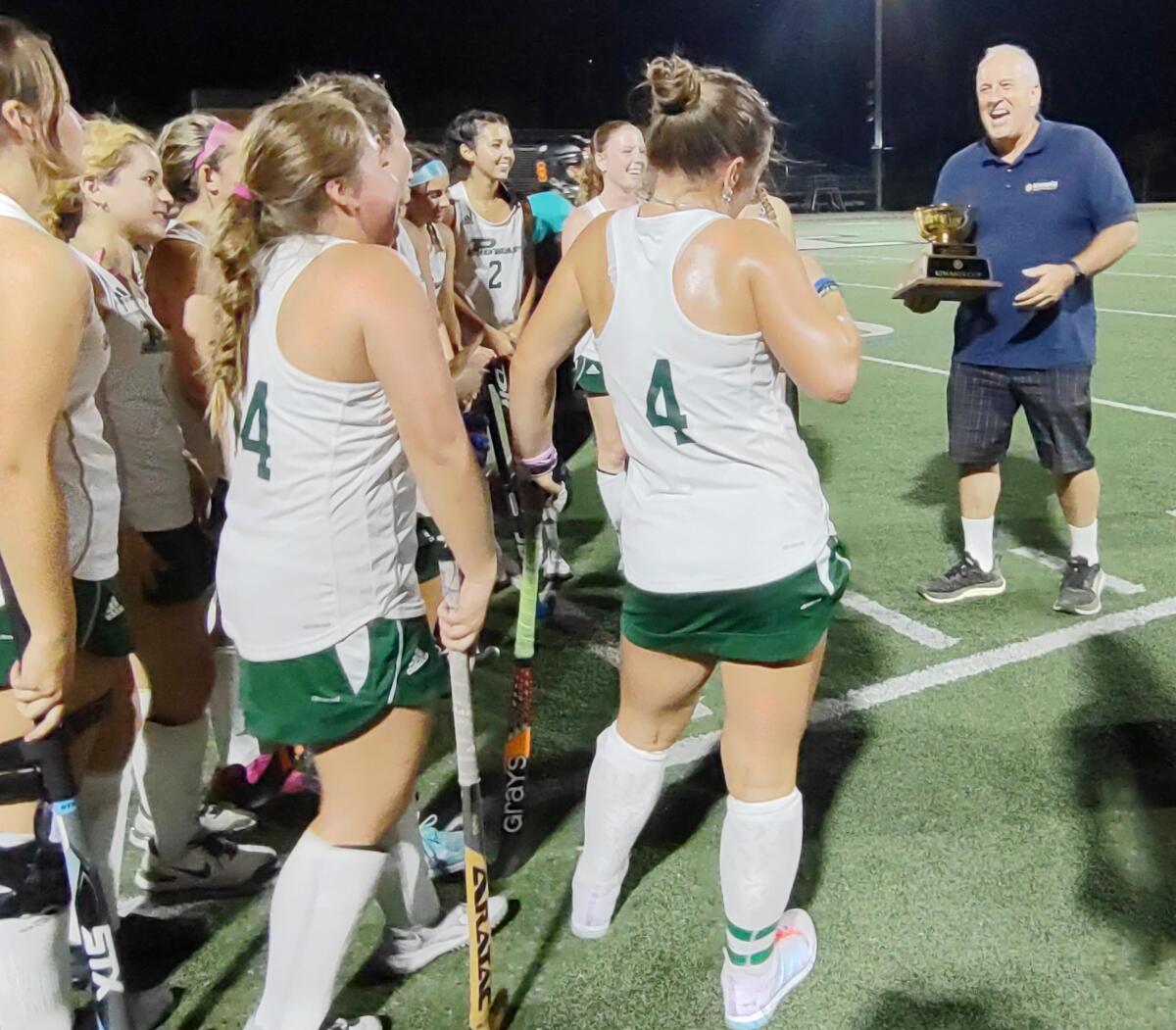 Kiwanis Club of Poway Foundation president John Couvrette delivers the inaugural Kiwanis Cup to the Titans field hockey team.