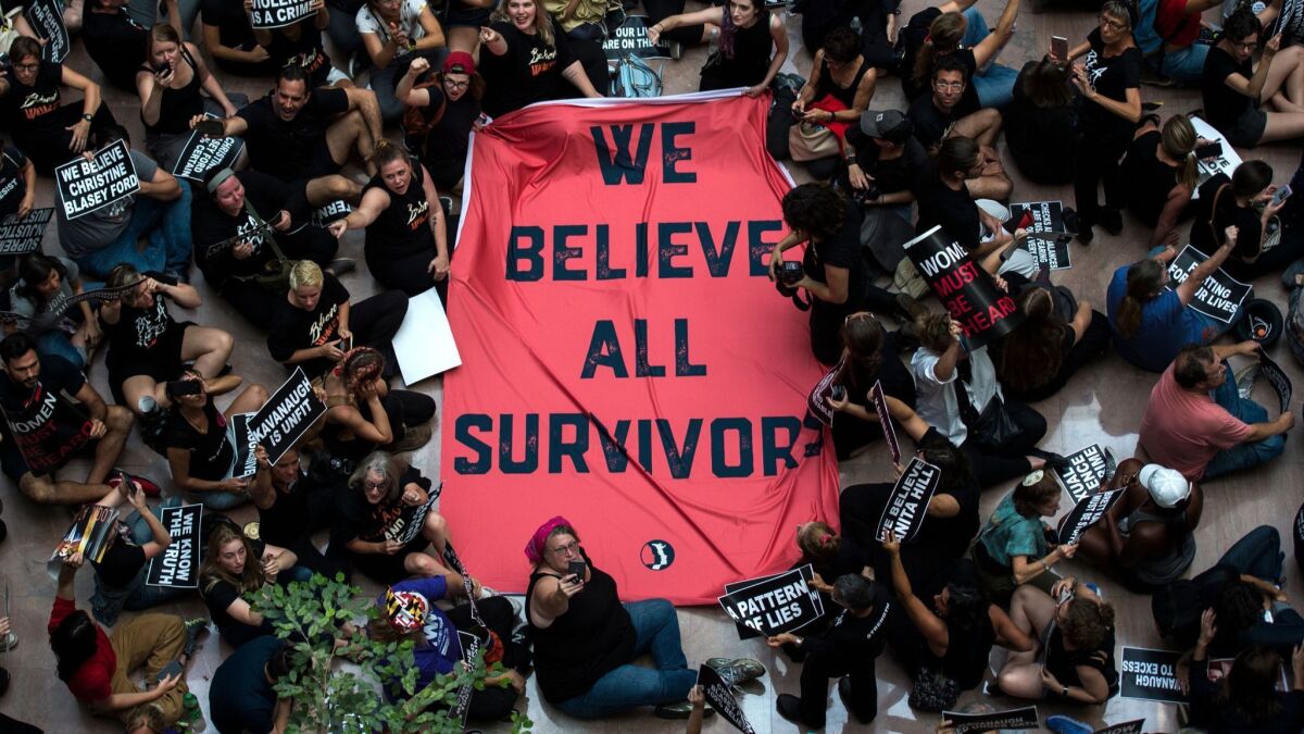Protesters unfurl a sign as they occupy the Senate Hart building during a rally against Supreme Court nominee Brett Kavanaugh on Capitol Hill in Washington, DC on October 4, 2018.