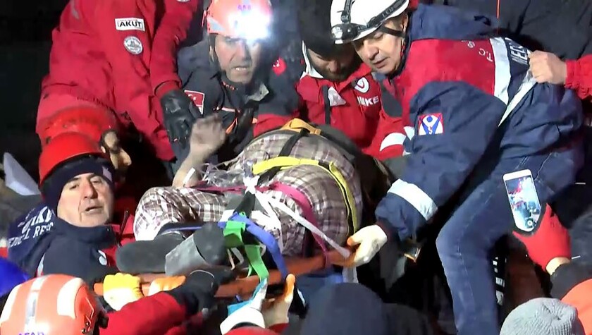 Rescue workers carry a wounded person after rescuing him from the debris of a collapsed building Saturday following a strong earthquake in Elazig in eastern Turkey on Jan. 24, 2020.
