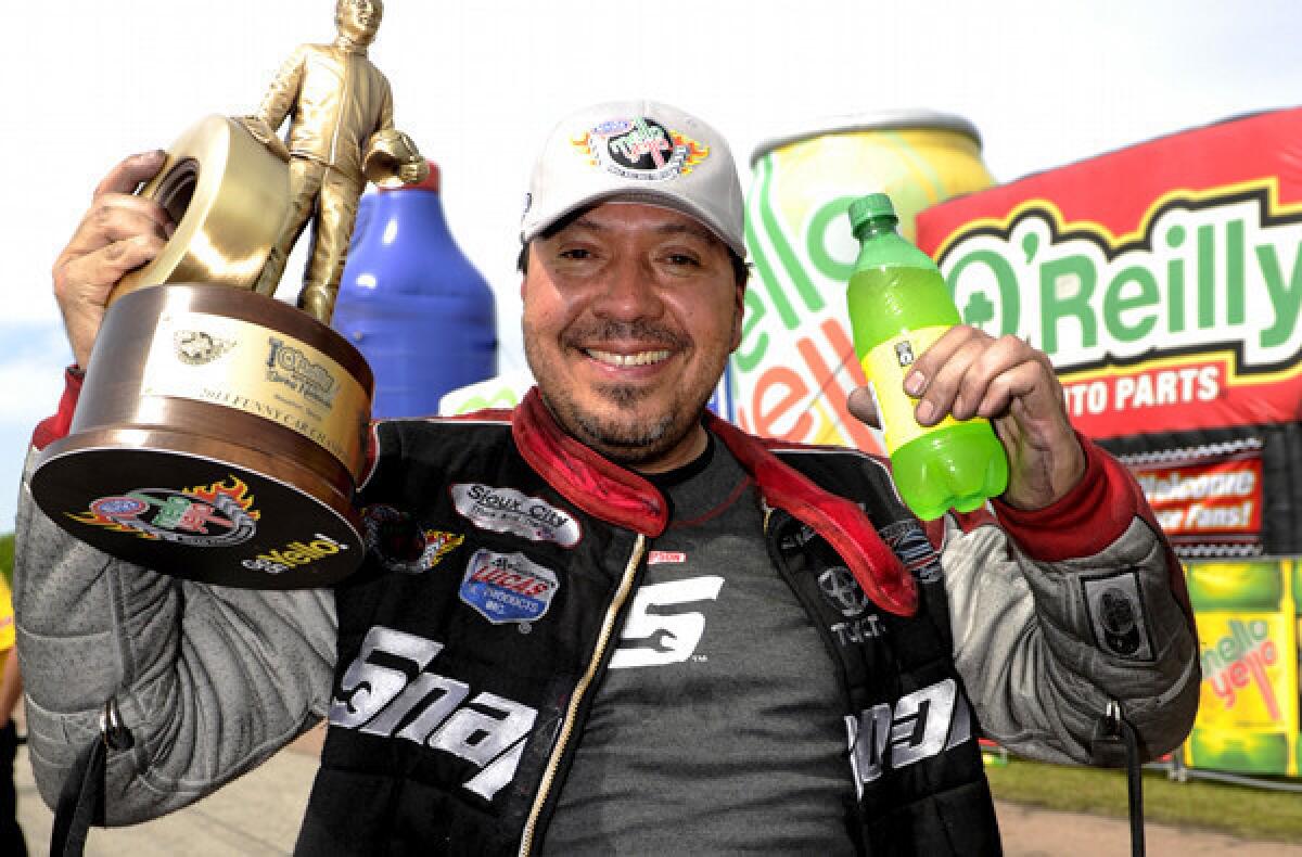 Cruz Pedregon celebrates his second Funny Car victory of the season in the O¿Reilly Auto Parts NHRA SpringNationals at Royal Purple Raceway in Baytown, Texas.