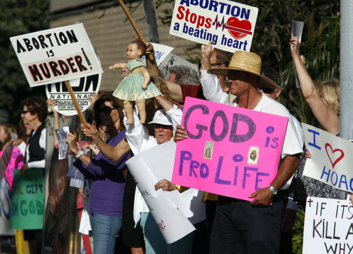 Demonstrators gather outside Hoag Hospital to celebrate its decision to halt elective abortions at the hospital in Newport Beach on June 20, 2013. Hoag's decision was announced after it partnered with a Catholic healthcare provider, though the administrators said the policy change on abortion was a business move by a hospital that performs fewer than 100 such procedures a year.