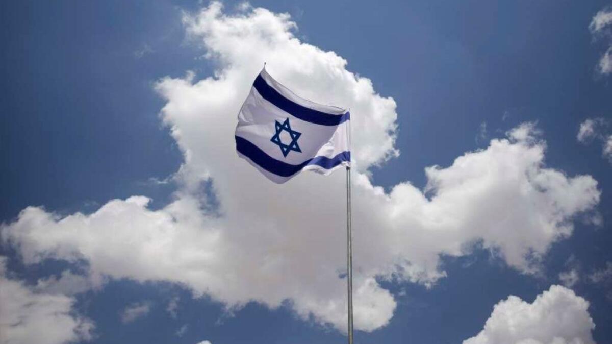 Wind blows through an Israeli flag hanging over Jerusalem's Old City in 2009.