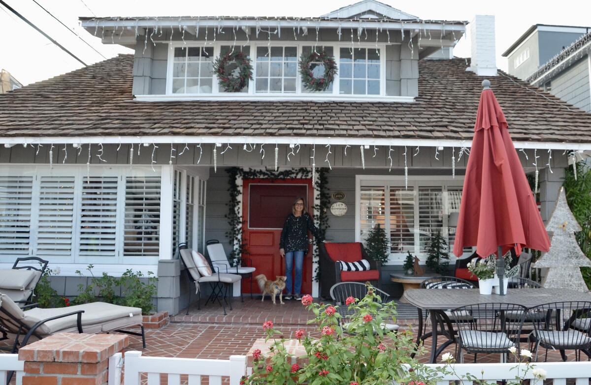 Irma Grime poses in front of her 1923 Sapphire Ave. cottage preparing for the Balboa Island Holiday Home Tour.