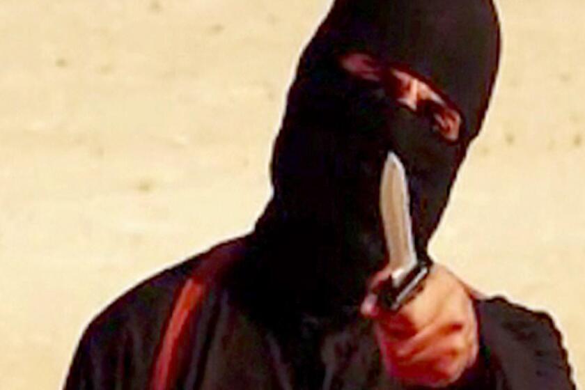 A frame from a video released by Islamic State shows the masked militant "Jihadi John" before beheading U.S. hostage Steven Sotloff.