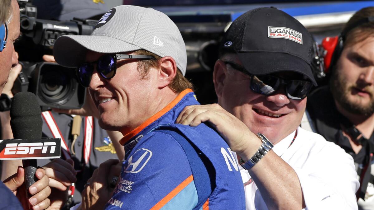 Scott Dixonis congratulated by car owner Chip Ganassi on Sunday afternoon after winning the pole for the Indianapolis 500.