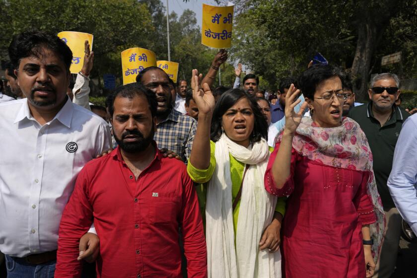 Members of Aam Admi Party, or Common Man's Party, shout slogans during a protest against the arrest of their party leader Arvind Kejriwal, in New Delhi, India, Friday, March 22, 2024. Supporters of an anti-corruption crusader and one of India's most consequential politicians of the last decade in India held protests Friday against his arrest, which opposition parties say is part of a crackdown by Prime Minister Narendra Modi's government before national elections. (AP Photo/Manish Swarup)