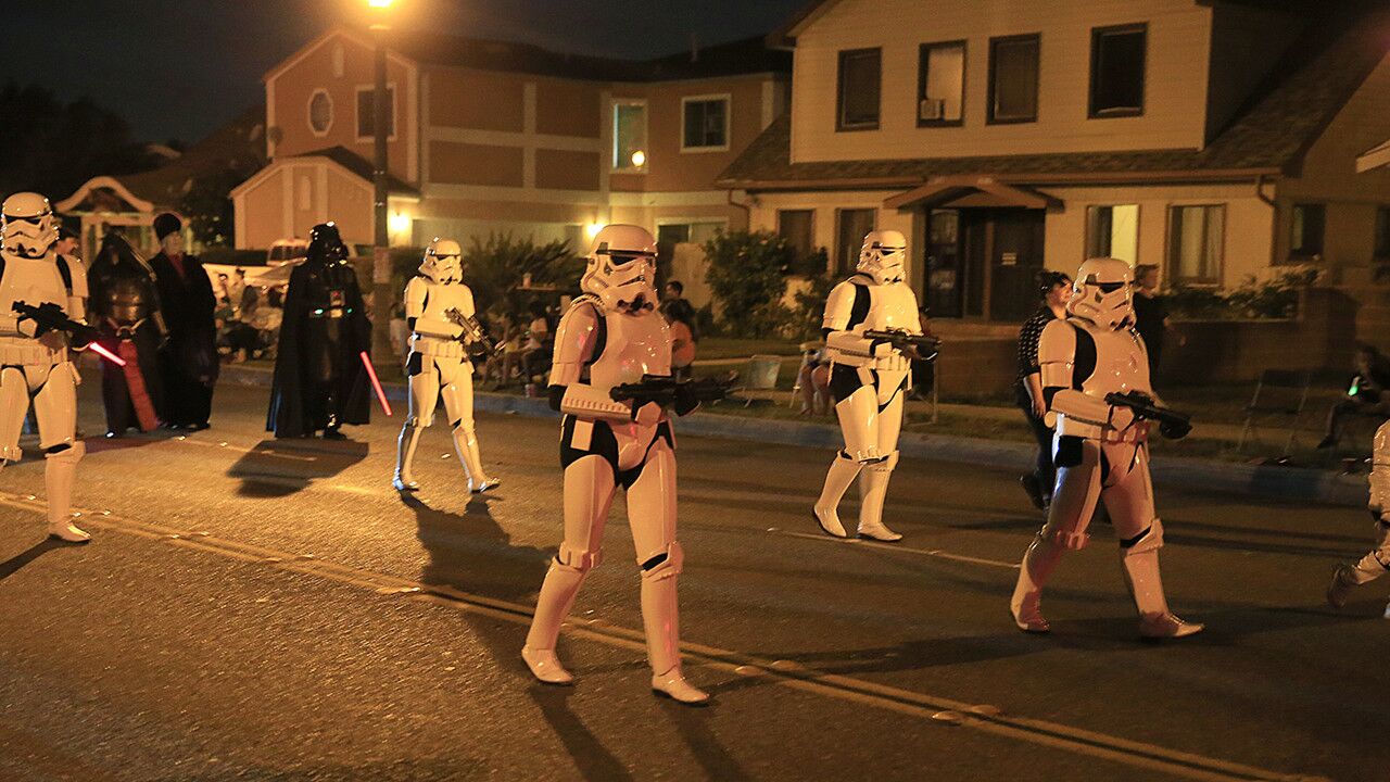 Members of the 501st Rebel Legion march by homes during the Anaheim Halloween Parade on Saturday.