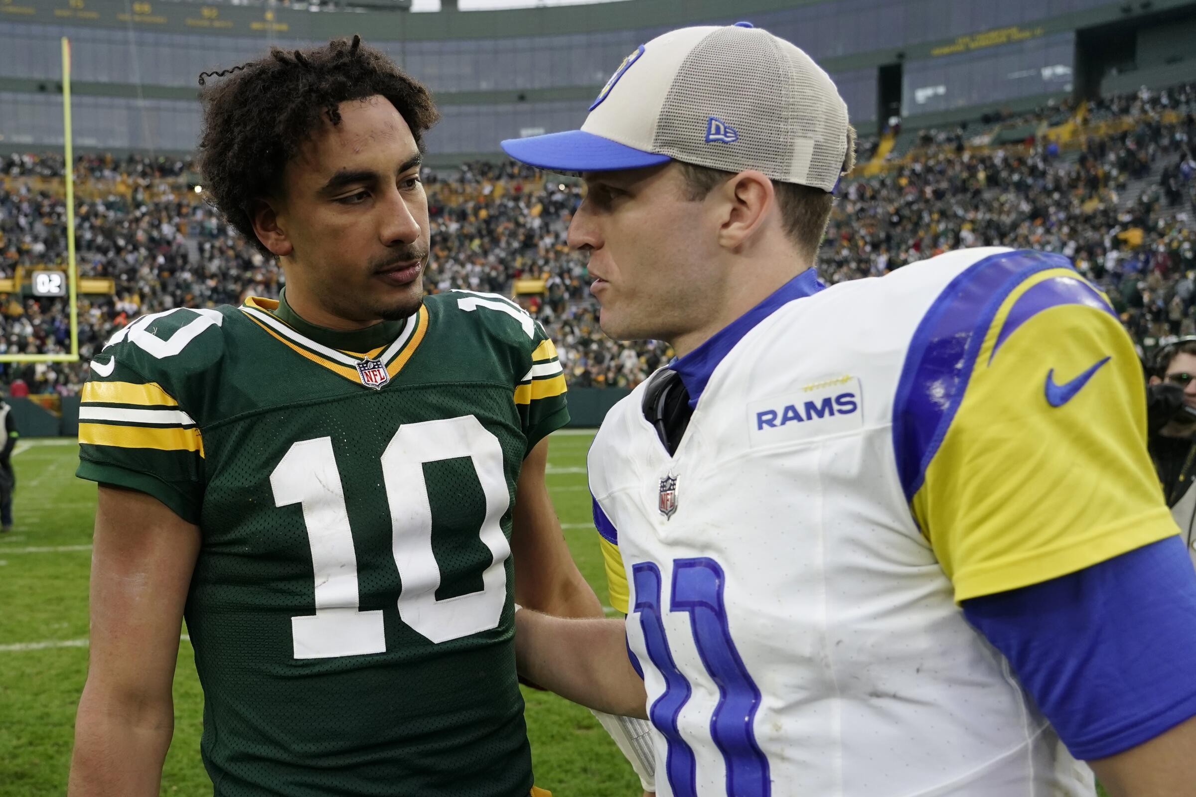 Packers quarterback Jordan Love (10) and Rams quarterback Brett Rypien (11) talk after a Green Bay's 20-3 win.
