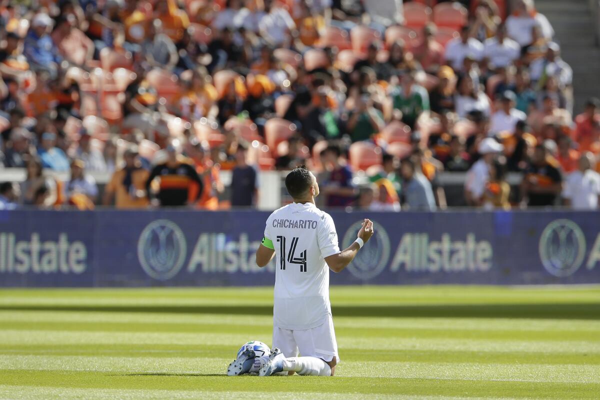 Galaxy forward Javier "Chicharito" Hernandez prays on the field before the team's season opener against the Houston Dynamo on Feb. 29.