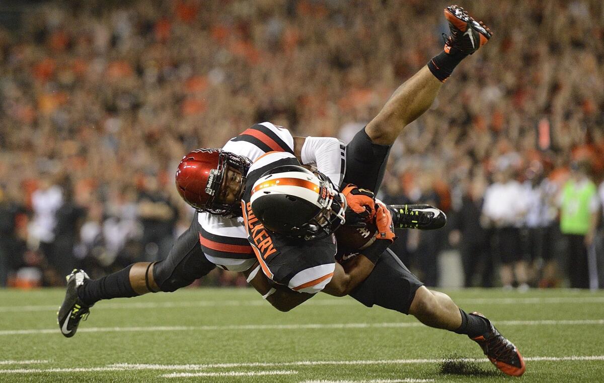Oregon State's Rahmel Dockery is tackled after a catch by Aztecs cornerback J.J. Whittaker in the second period.