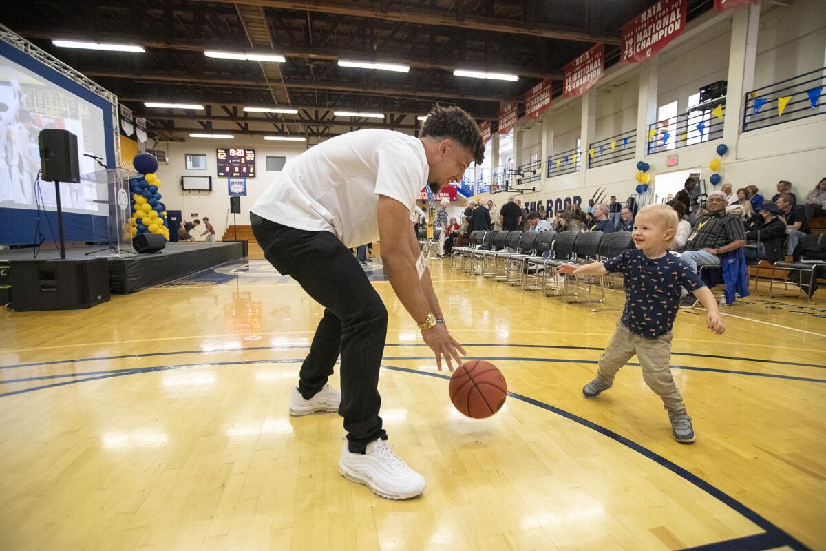 Isaac Davis plays basketball with Caden Dorn during a ceremony at Vanguard University to say goodbye to the Pit.