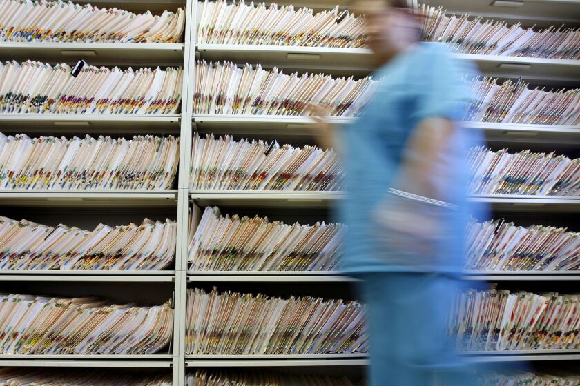 Bulky paper medical records like the ones in this 2006 photo were inconvenient, but they may have had this advantage over electronic patient files: security.
