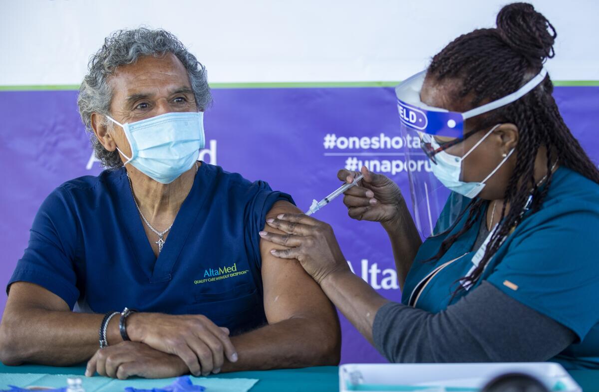 A healthcare worker gives a vaccine to Antonio Villaraigosa.