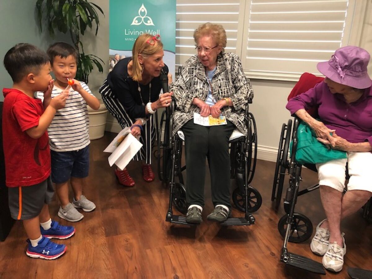 Two 4-year-old boys with Vi community relations manager Theresa Latosh, Captain Georgia McKearly and Evelyn Murray. gather Sept. 22, 2019 for a National Centenarian Day event held at the senior living community, Vi at La Jolla Village.