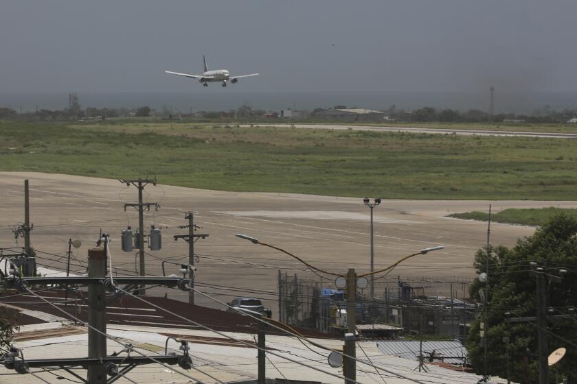 A plane prepares to land as it arrives at the Toussaint Louverture International Airport in Port-au-Prince, Haiti, Monday, May 20, 2024. Haiti's main international airport reopened Monday for the first time in nearly three months after gang violence forced authorities to close it in early March. (AP Photo/Odelyn Joseph)