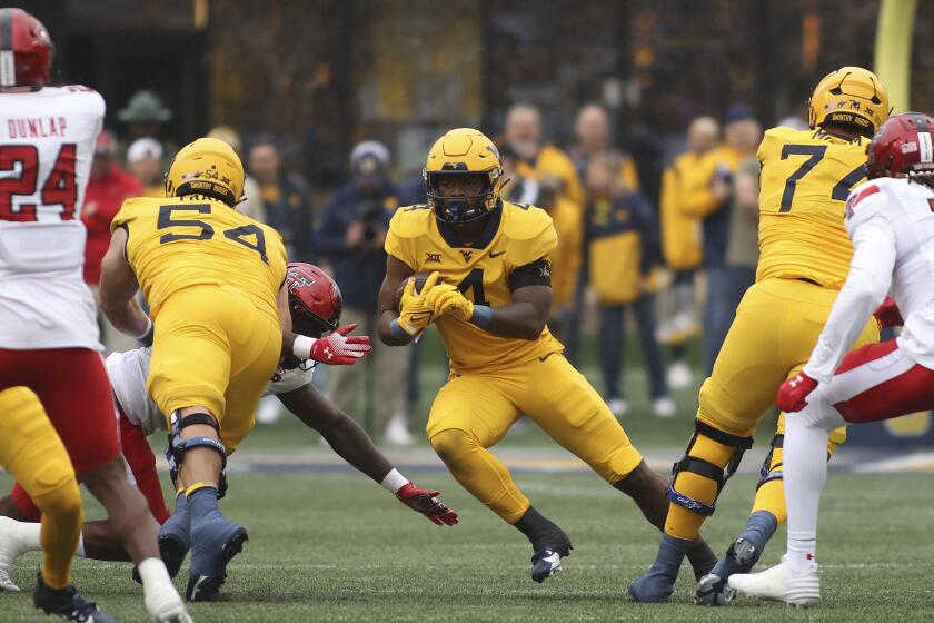 West Virginia running back C.J. Donaldson (4) carries the ball during the first half of an NCAA college football game against Texas Tech, Saturday, Sept. 23, 2023, in Morgantown, W.Va. (AP Photo/Chris Jackson)