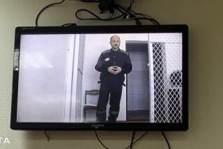 In this photo taken from video released by Russian independent news outlet SOTA telegram channel, Russian opposition activist Vladimir Kara-Murza is seen on a TV screen during a video broadcast provided by the Russian Federal Penitentiary Service during a hearing, at Zamoskvoretsky court, in Ufa, Russia, Thursday, Feb. 22, 2024. Jailed opposition politician Vladimir Kara-Murza on Thursday urged Russians to keep fighting for democracy despite the death of Alexei Navalny in an Arctic prison. (Russian independent news outlet SOTA telegram channel via AP)