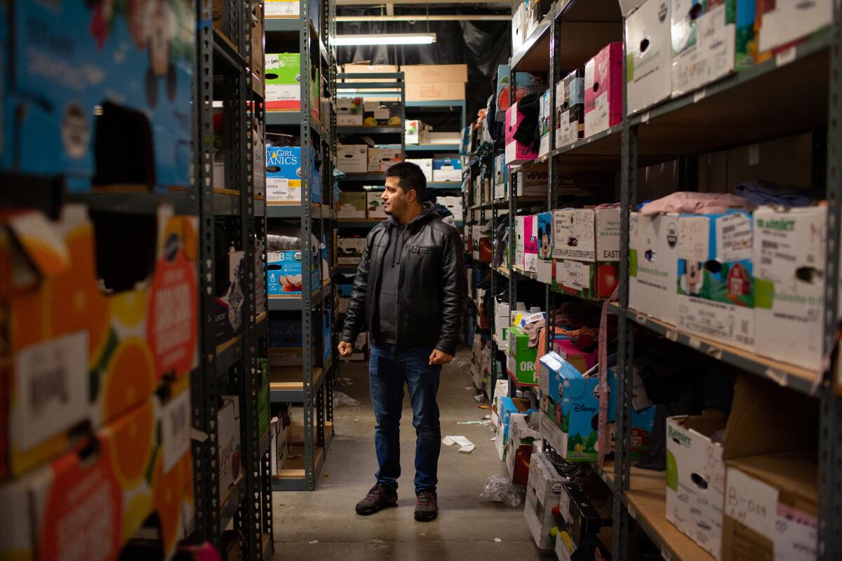 Emal Salarzai stands inside the warehouse at his e-commerce business in Sacramento.