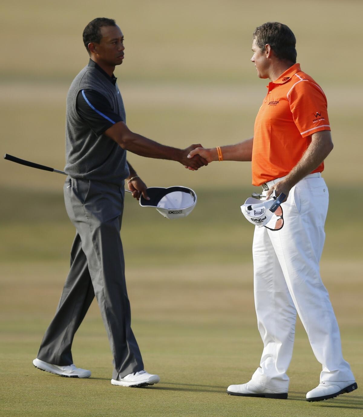 Tiger Woods, left, shakes hands with Lee Westwood following the completion of the third round of the British Open on Saturday.