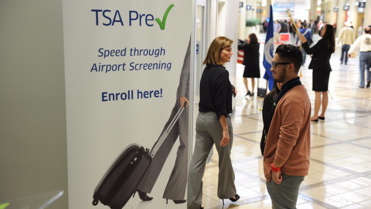 A poster announcing the TSA Precheck program is seen outside the PreCheck enrollment office, at Los Angeles International Airport.