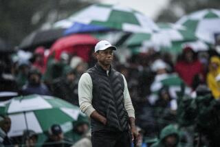 Tiger Woods waits to play on the 18th hole during the weather delayed second round of the Masters golf tournament at Augusta National Golf Club on Saturday, April 8, 2023, in Augusta, Ga. (AP Photo/Matt Slocum)