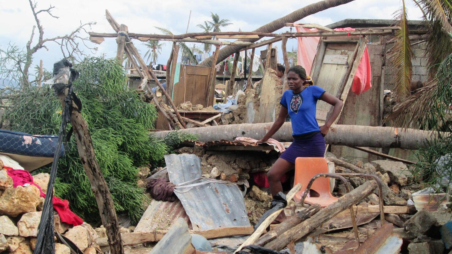 This handout photo obtained from the Agency for Technical Cooperation and Development Assistance on October 7, 2016 shows a woman looking on in the devasted town of Jeremie, west Haiti, following Hurricane Matthew.