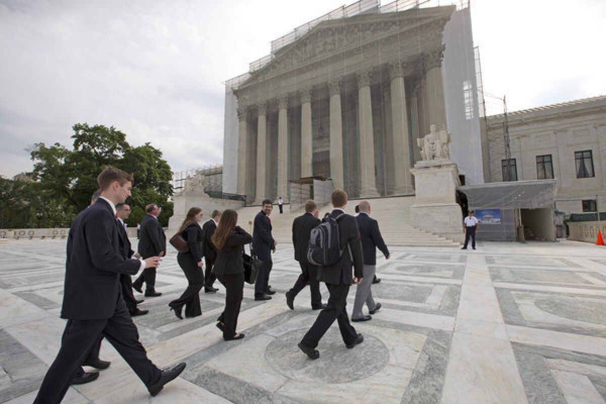 Law students visiting from Liberty University in Lynchburg, Va., arrive at the Supreme Court in Washington.