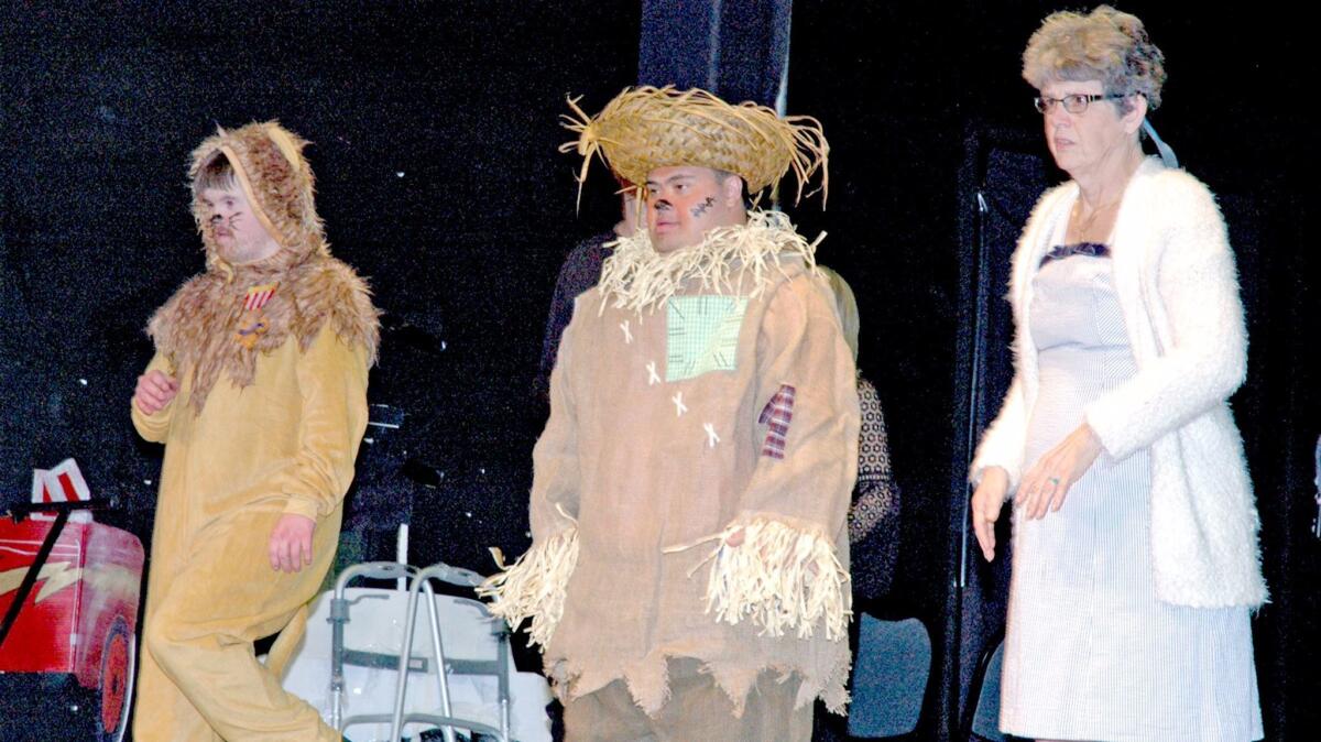 Jeff Bedard, from left, is the Lion, Andrew Sacasas plays the Scarecrow and JoEllen Bosset as Dorothy in "Ease on Down the Road" from the Broadway musical "The Wiz."