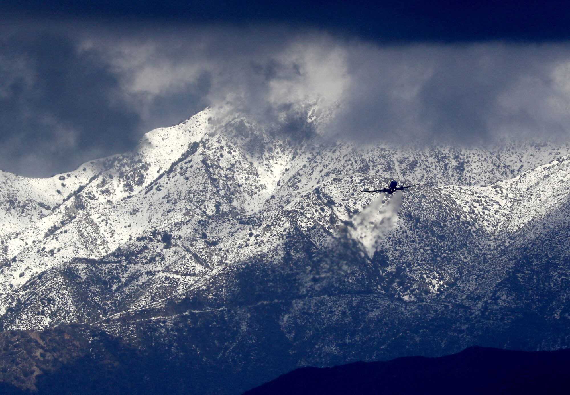 Snow-covered mountains serve as a backdrop for airplanes flying over the San Fernando Valley on Feb. 28.