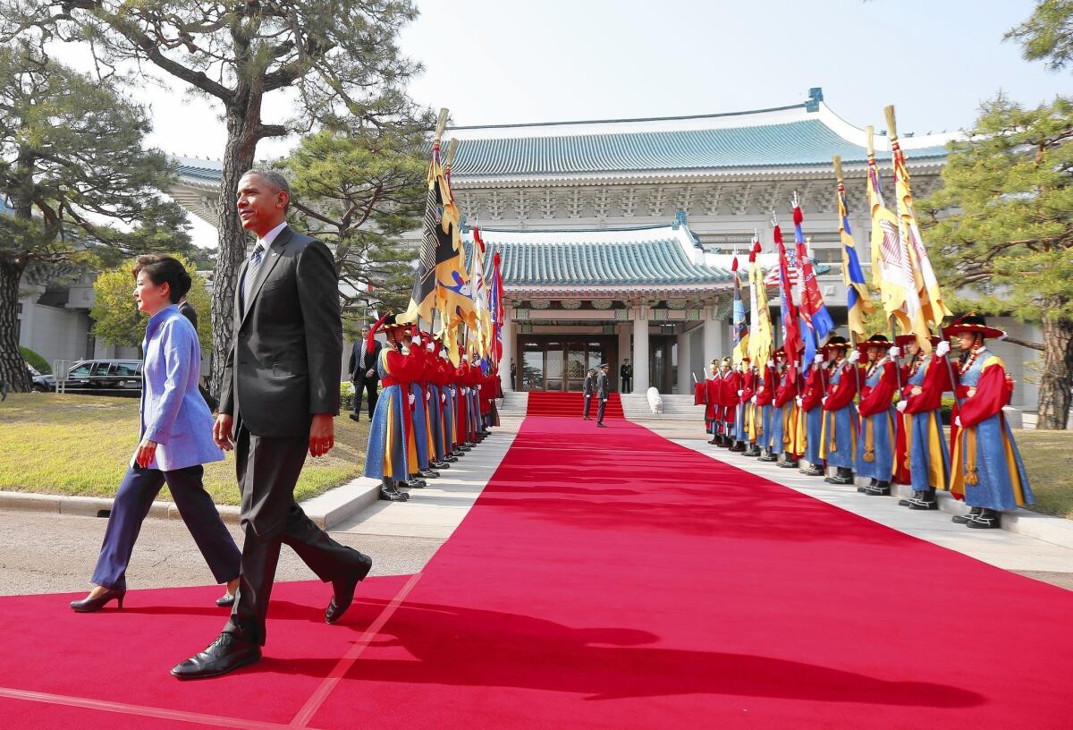 President Obama walks with South Korean President Park Geun-hye at the presidential palace in Seoul. He flew there from Tokyo, where he and Japanese Prime Minister Shinzo Abe failed to reach a breakthrough on a 12-nation free-trade accord.