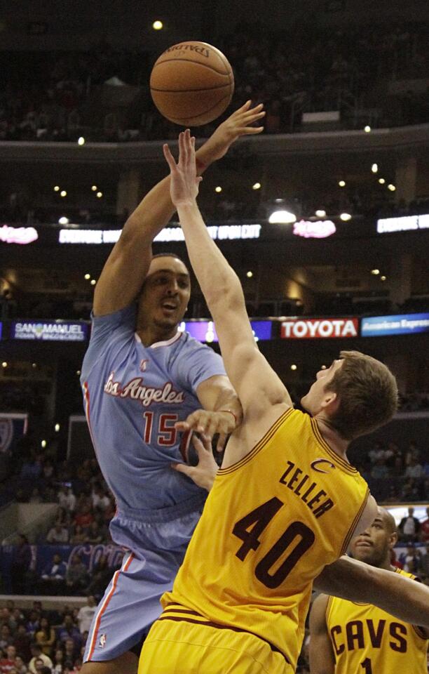 Clippers center Ryan Hollins, left, tries to shoot over Cleveland Cavaliers center Tyler Zeller during the second half of the Clippers' 102-80 win Sunday at Staples Center.