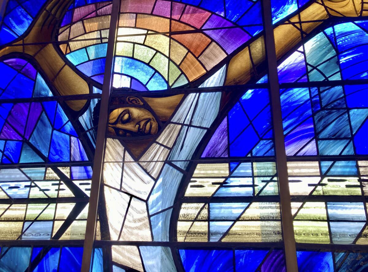 A stained glass window depicting Jesus as a Black man.