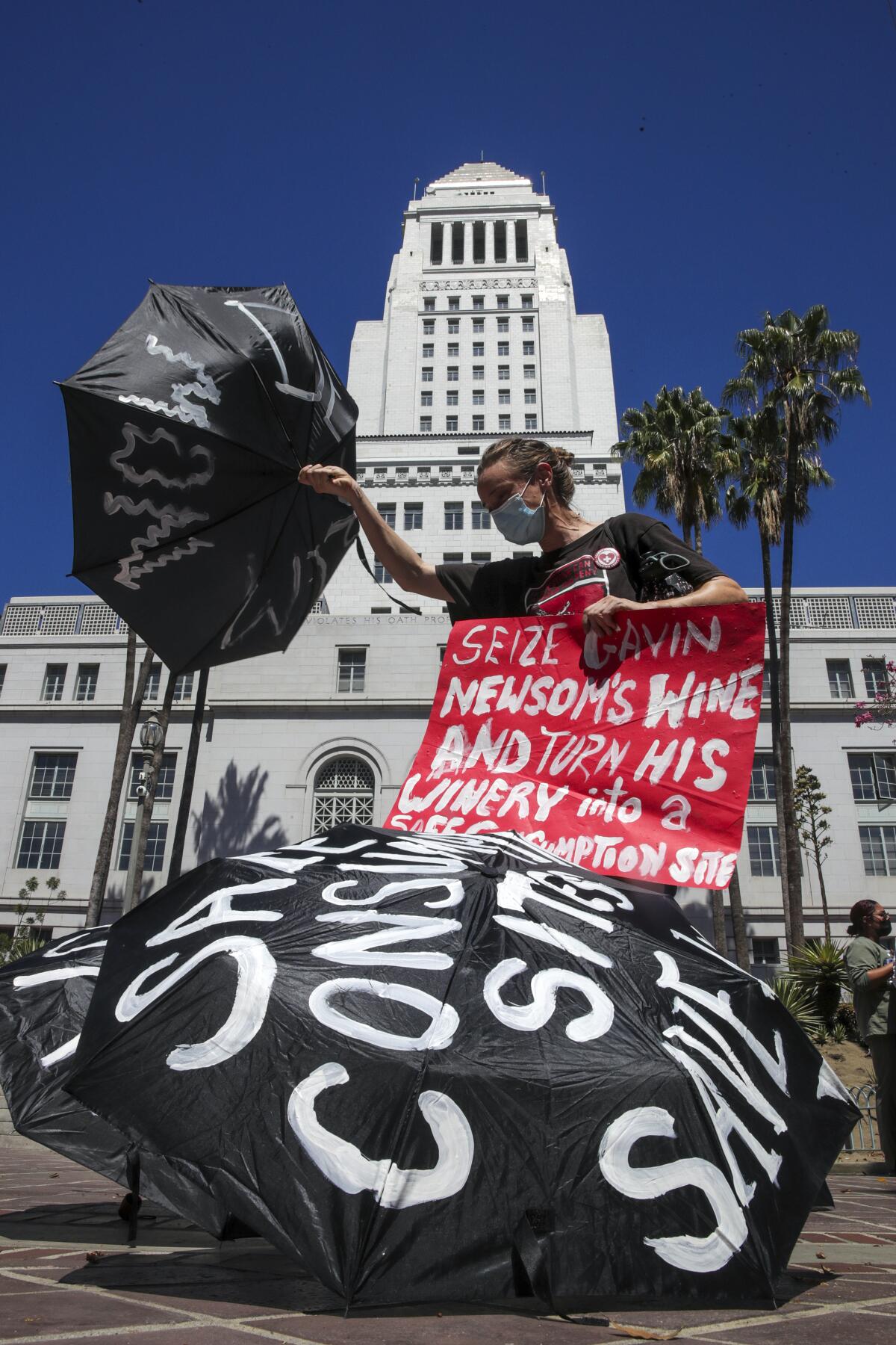 Joanna Swan, from Street Watch LA, at rally held to mark International Overdose Awareness Day outside City Hall on Wednesday.