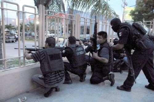 Policemen and members of the Mexican Army during a hostage crisis in a mall in Mazatlan, Mexico. For more than two hours a group of armed gunmen took some 40 hostages after assassinating a State Prevention Police officer. In spite of an intense mobilization which included the Mexican Army, the Federal Prevention Police, and State Ministerial Police, the gunmen still managed to escape.