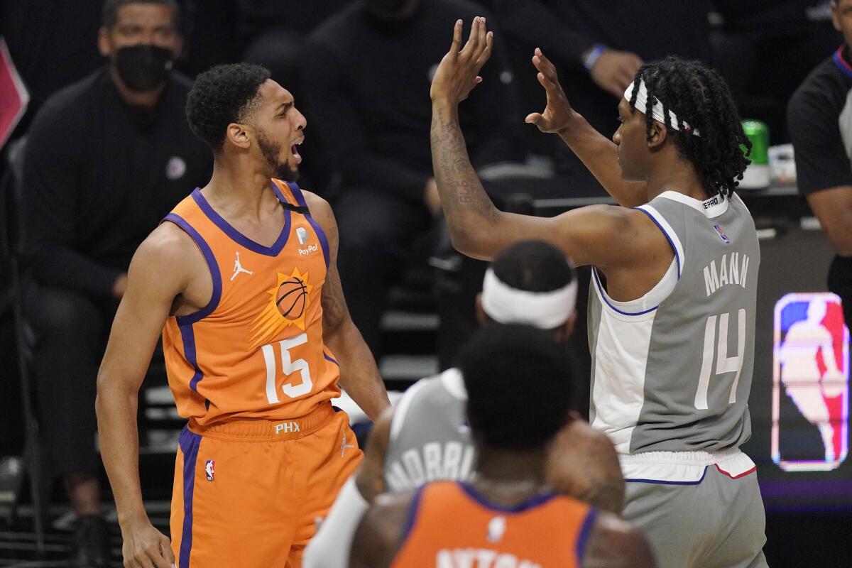 Suns guard Cameron Payne, left, and Clippers guard Terance Mann have words during Game 4.