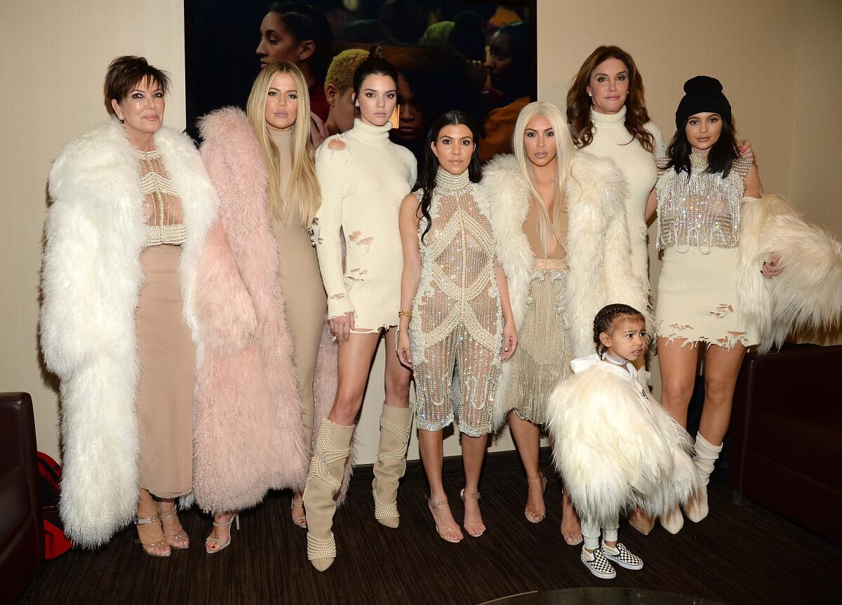The Kardashian and Jenner women pose together in fur coats and sparkling gowns