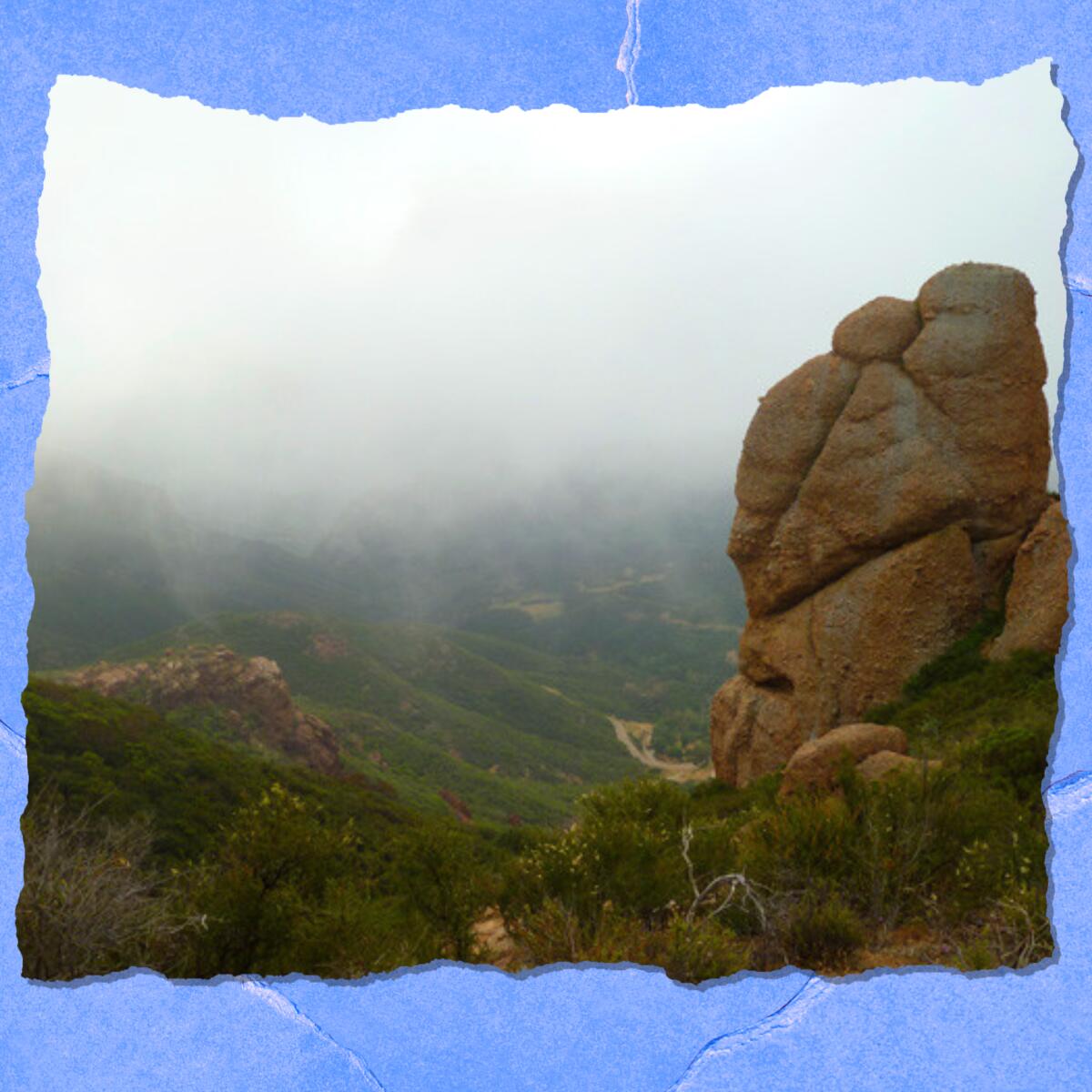 Sandy bounders and a green valley covered by mist.